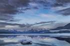 Clouds reflect in opening in the ice on Lake McDonald in Glacier National Park, Montana, USA. Art Print